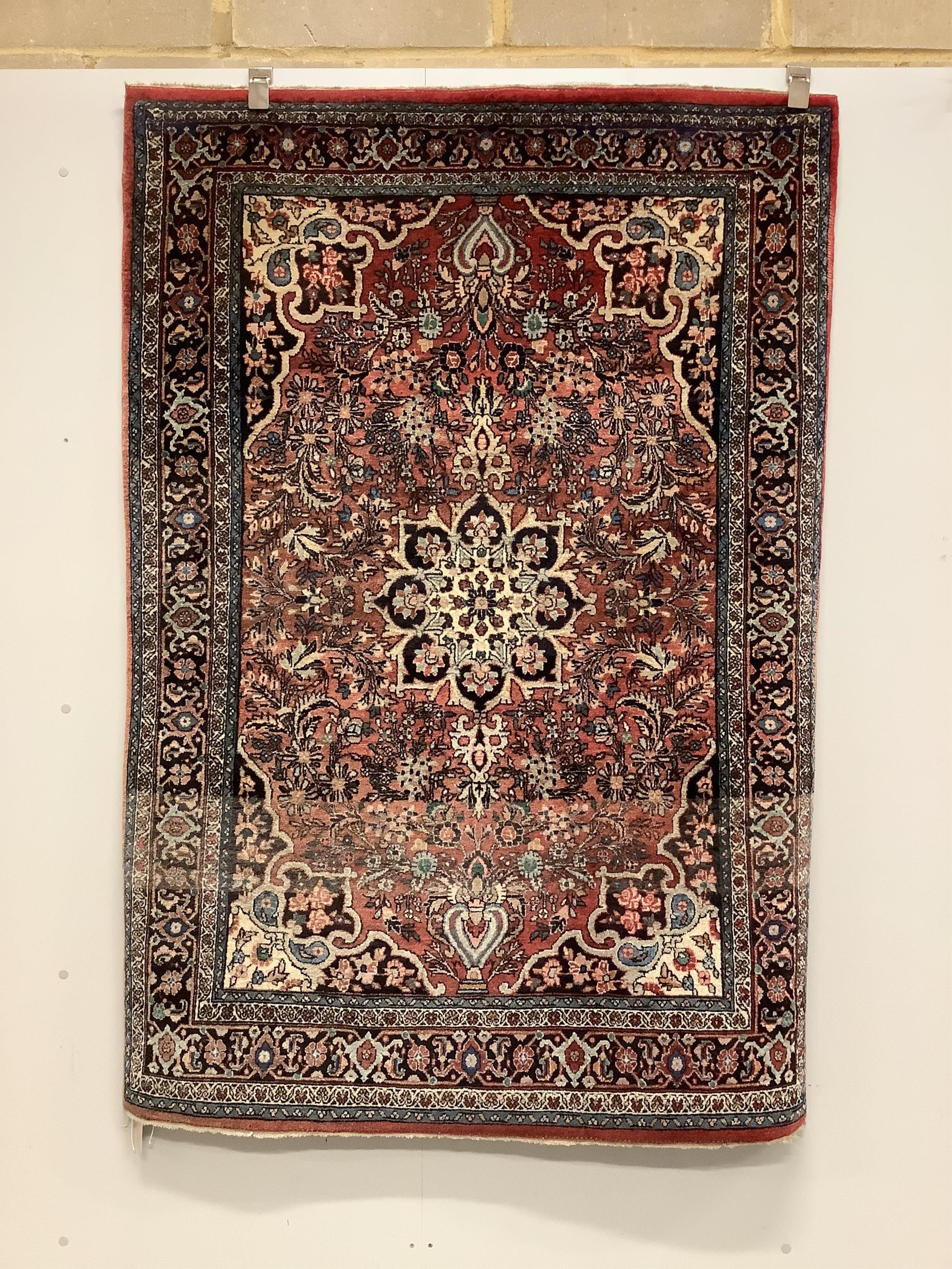 A Tabriz red ground rug, 166cm x 114cm. Condition - fair, lower third faded.